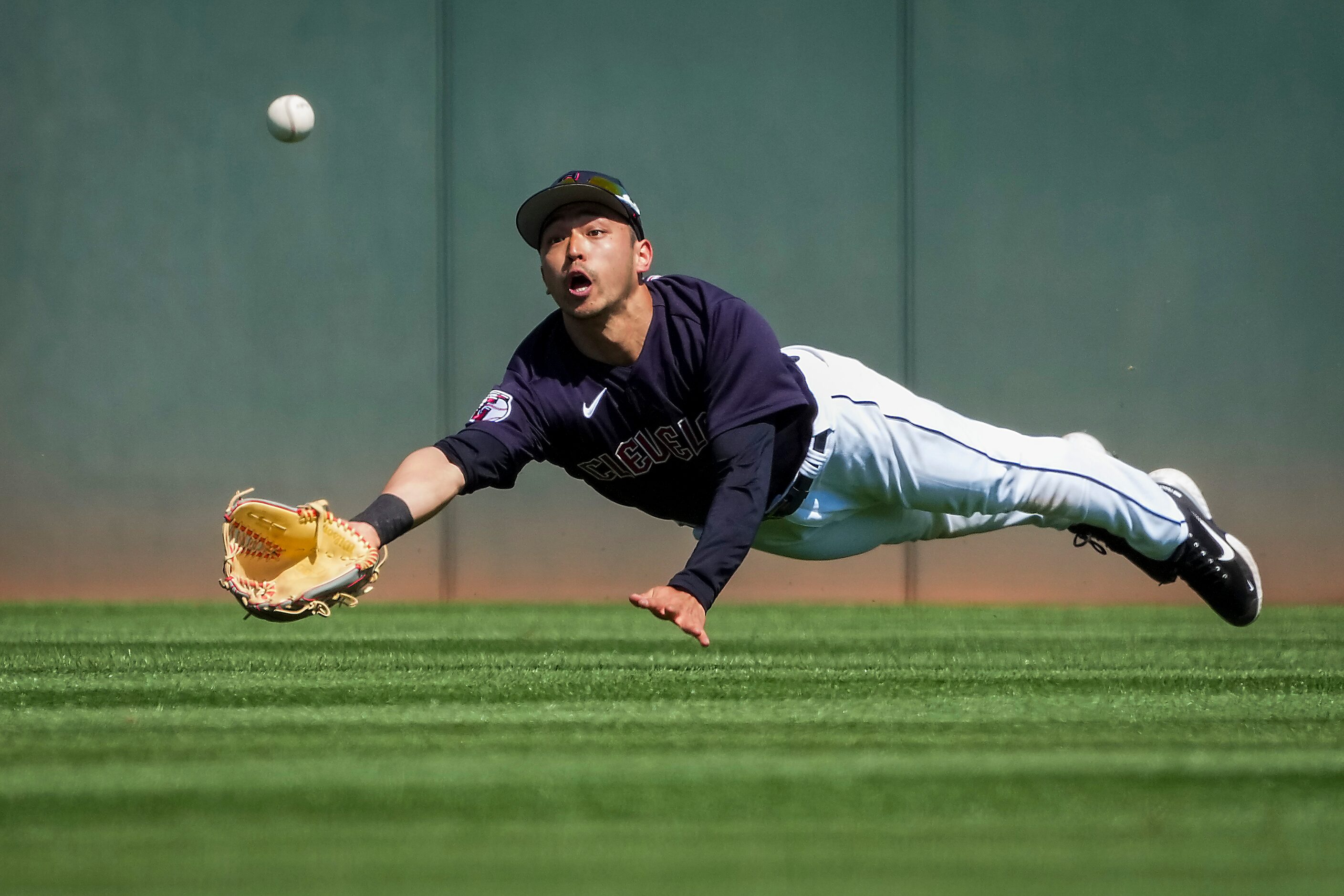 Cleveland Guardians center fielder Steven Kwan can’t make a diving catch on a double off the...