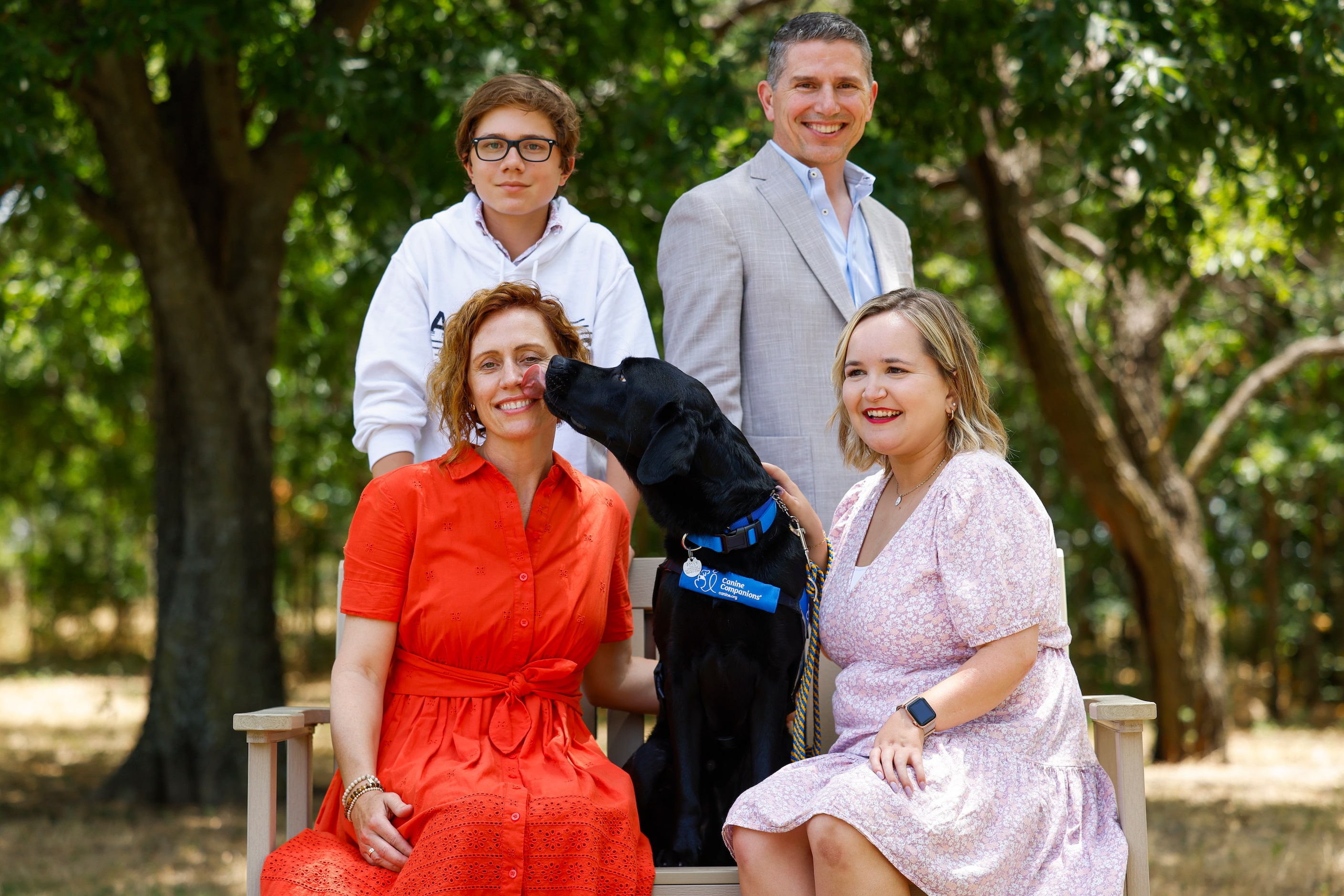 Puppy raiser Michaela Durisek (front left), her son Sebastian, husband Nick, pose for a...