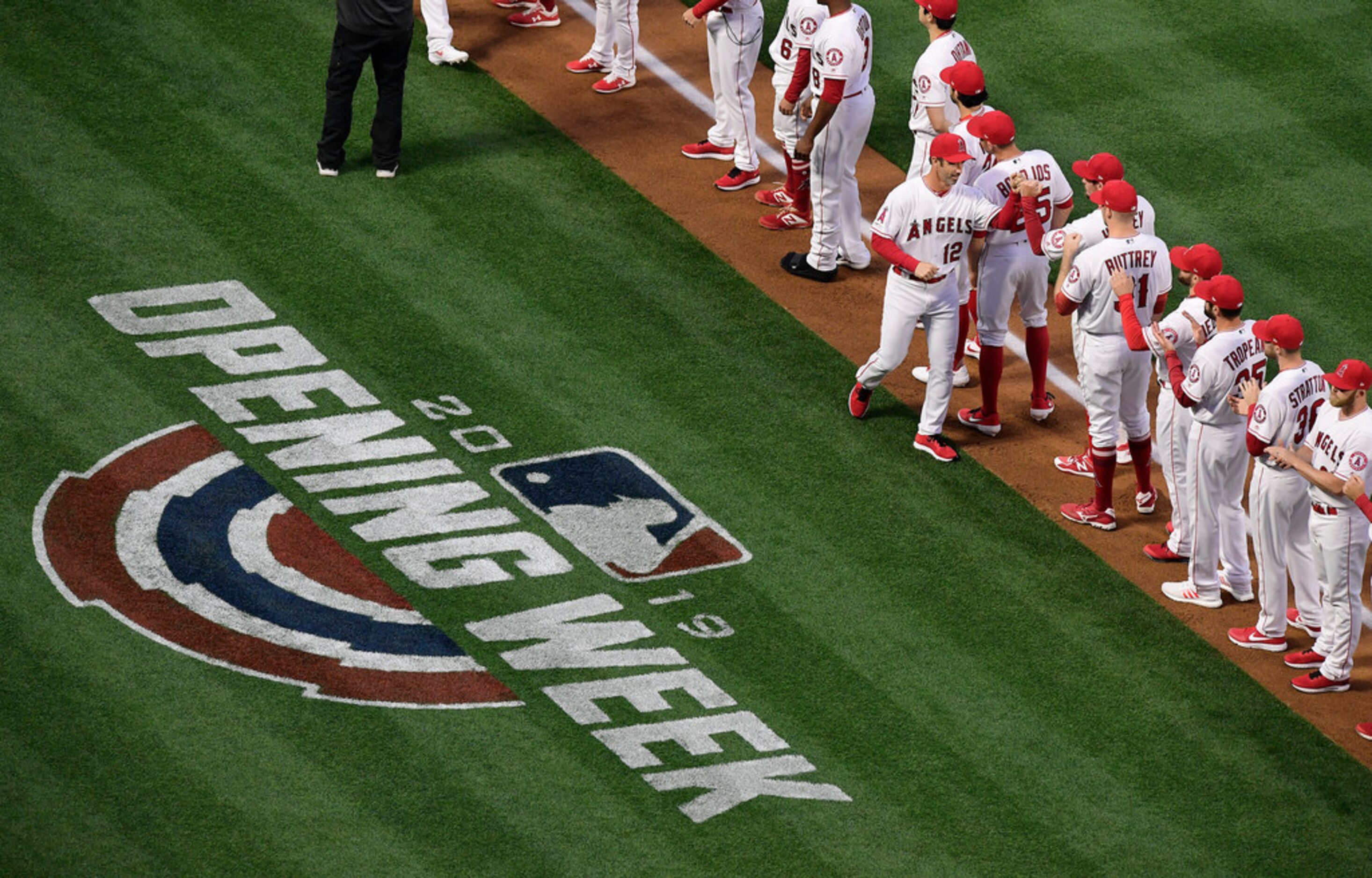 Los Angeles Angels manager Brad Ausmus greets members of his team before the team's...