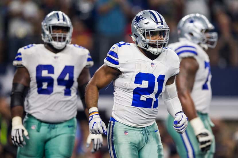 Dallas Cowboys running back Ezekiel Elliott (21) smiles after scoring a touchdown during the...