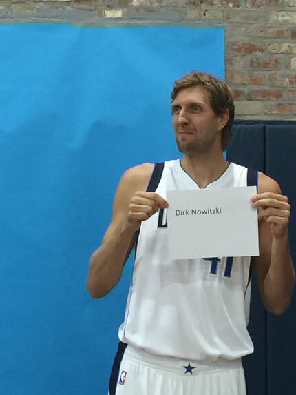 Dallas Mavericks forward Dirk Nowitzki holds a sign with his name on it during Mavericks...
