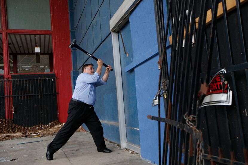 Garland City Council member Rich Aubin swung a sledgehammer into the Hypermart building...