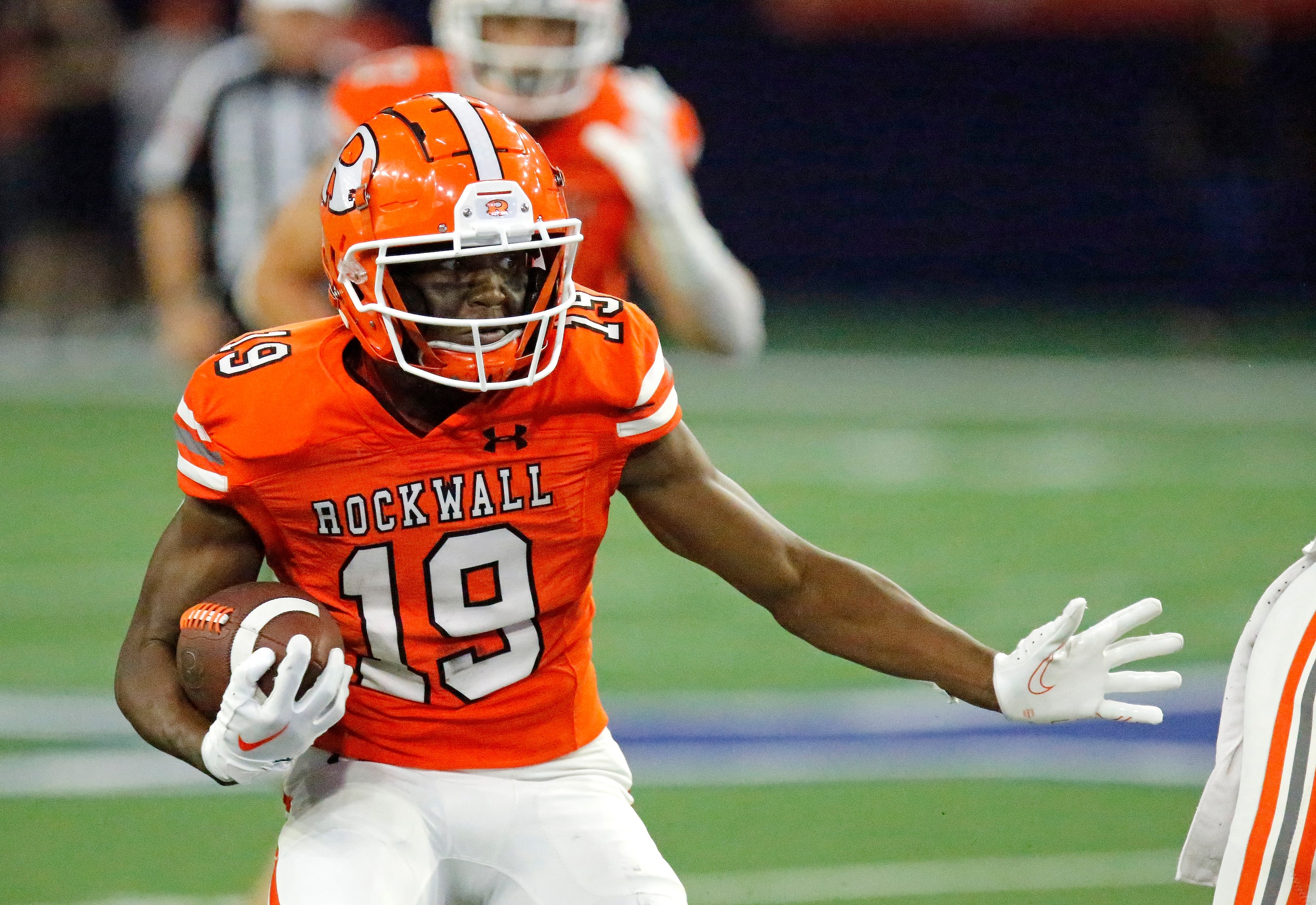 Rockwall High School wide receiver Camron Marsh (19) carries the ball during the first half...