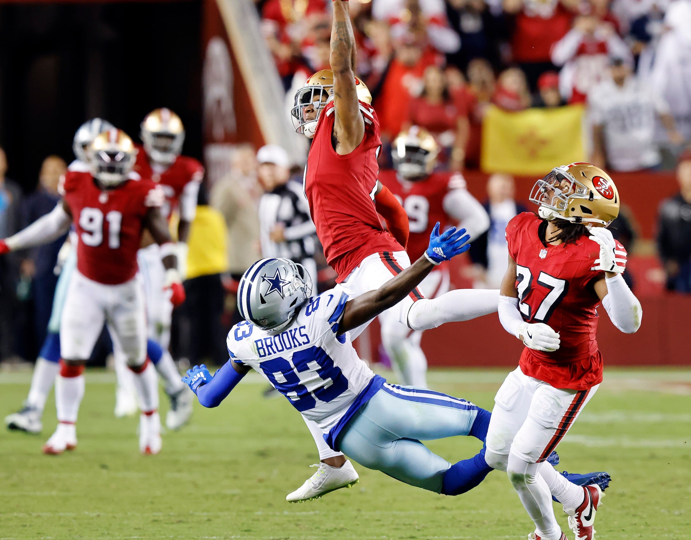 Dallas Cowboys wide receiver Jalen Brooks (83) leaps for a pass as he’s covered by San...