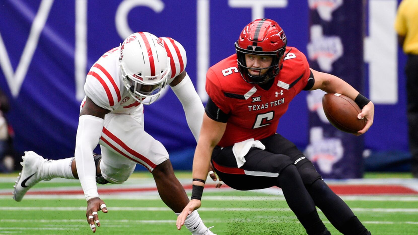 Texas Tech quarterback McLane Carter escapes a would-be tackle by Ole Miss defensive end...