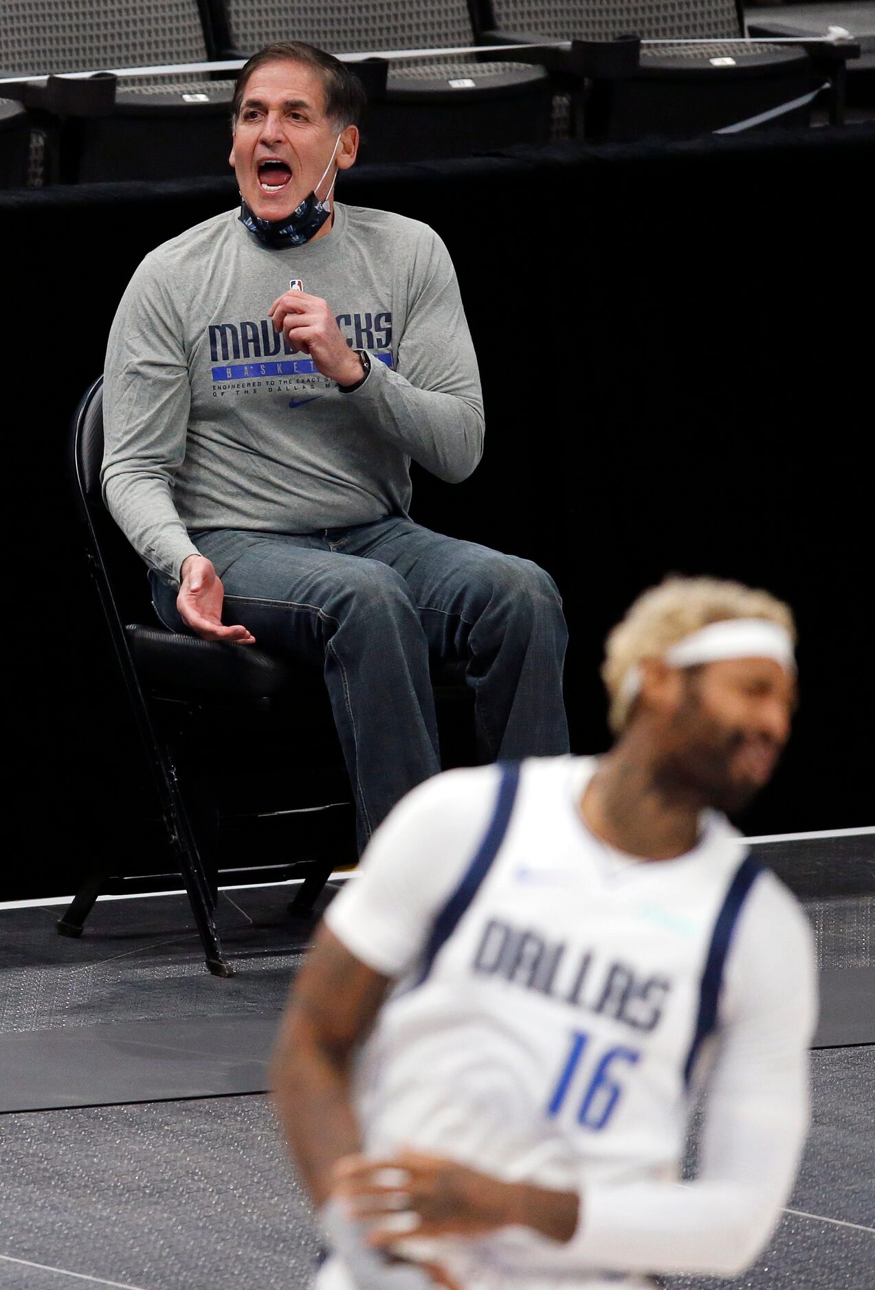 Dallas Mavericks owner Mark Cuban argues a call from his socially distanced seat along the...