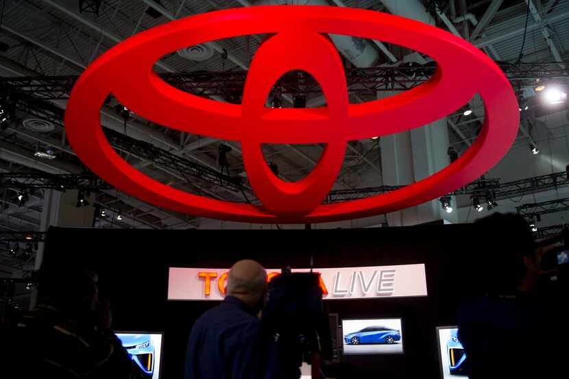 The Toyota Motor Corp. logo hangs above a news conference at the Washington Auto Show in...