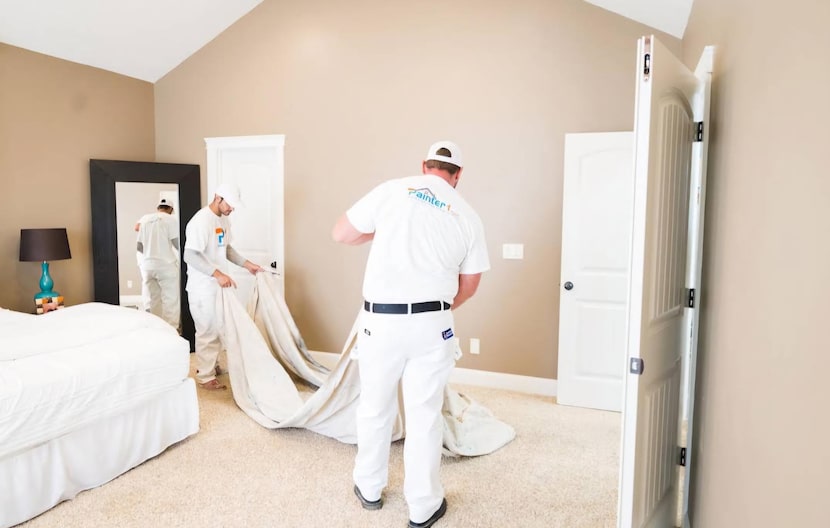 Men with a drop cloth in a bedroom