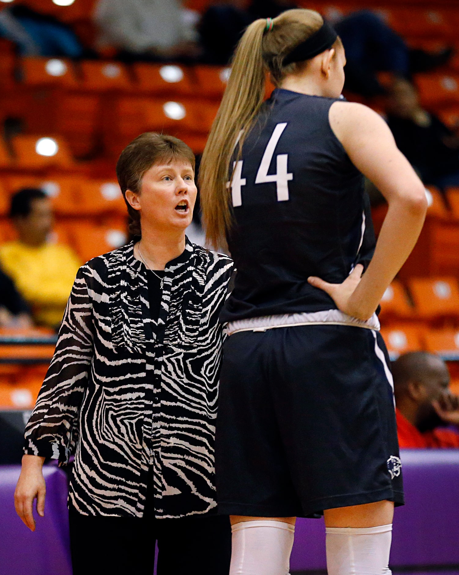 Flower Mound head coach Sherika Nelson speaks with center Lauren Cox (44) after Cox...