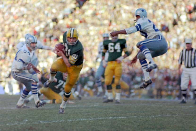 Green Bay Packers Jim Taylor runs with a Bart Starr pass as the Dallas Cowboys' Mel Renfro...