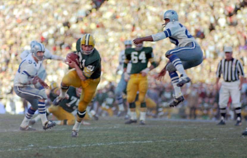 Green Bay Packers Jim Taylor runs with a Bart Starr pass as the Dallas Cowboys' Mel Renfro...