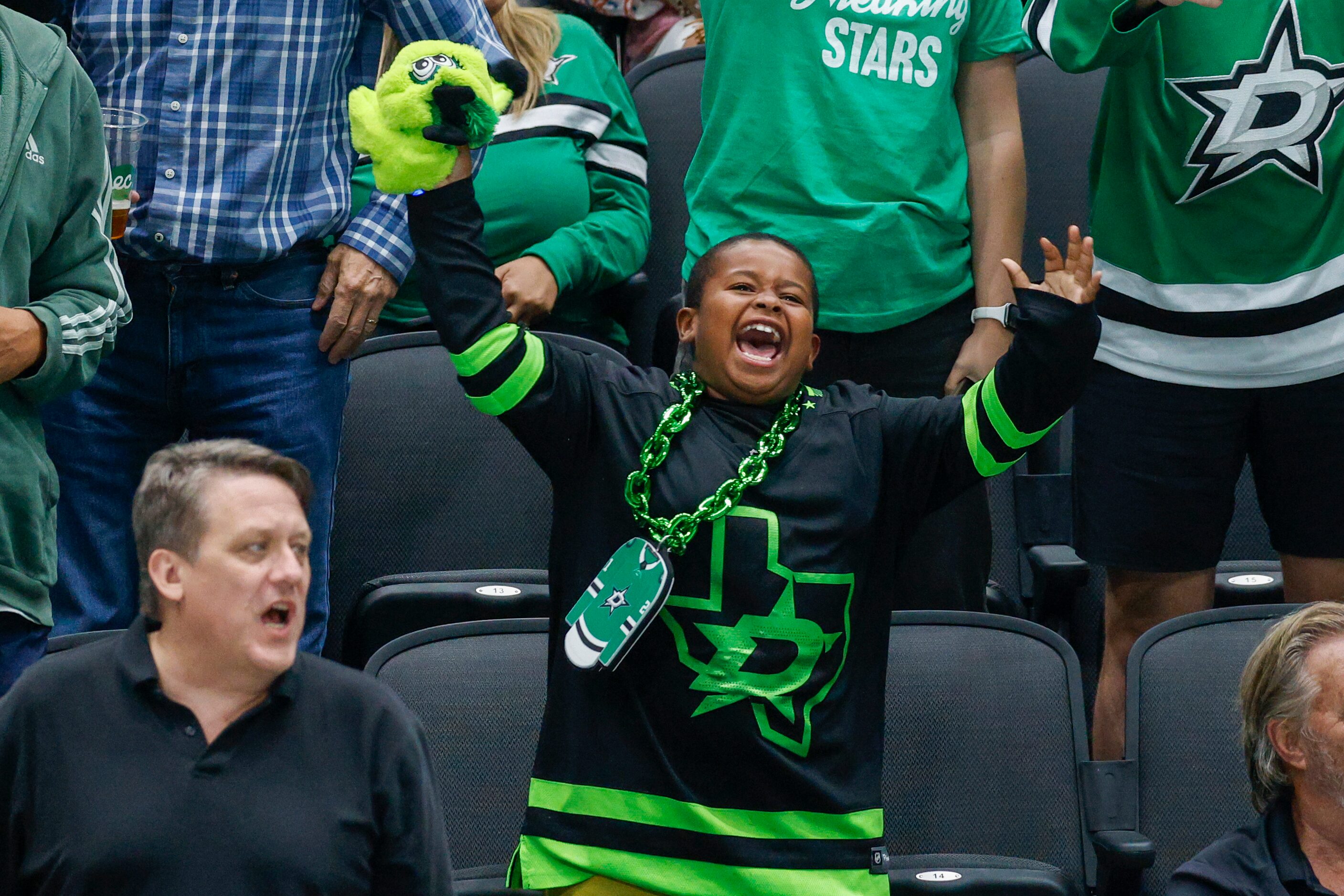 A young Dallas Stars fan celebrates a goal by Dallas Stars left wing Jason Robertson (21)...