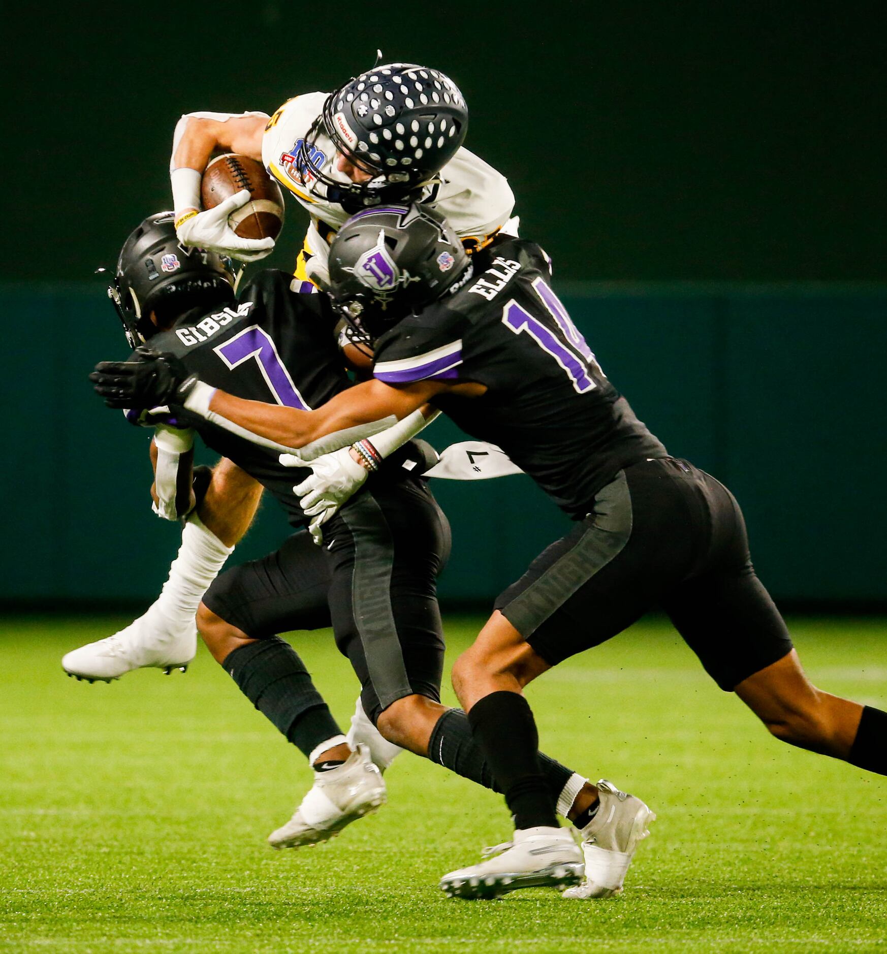 Highland Park's John Rutledge (85) is tackled by Frisco Independence's Andrae Gibson (7) and...