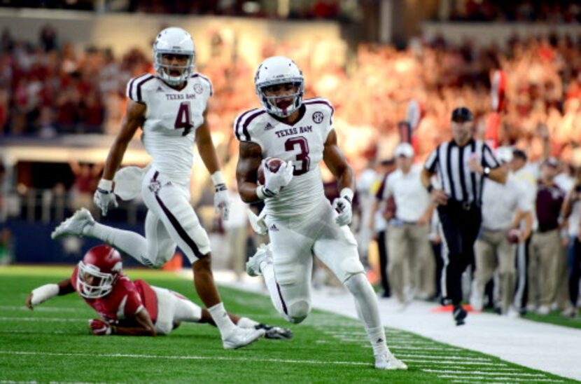 Texas A&M's Christian Kirk (3) runs down the sideline before scoring a touchdown against...