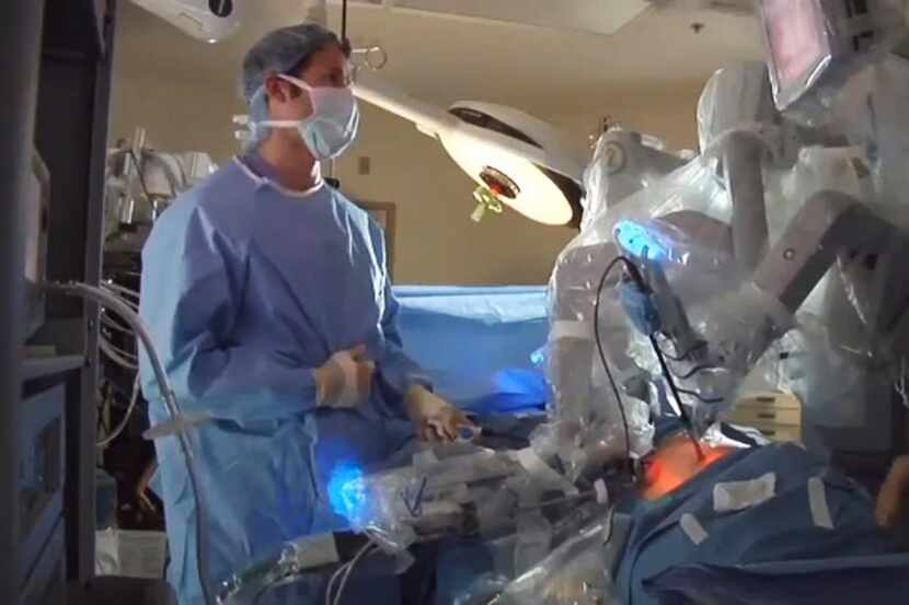 In this photo from video provided by Intuitive Surgical, doctors are seen using the device...