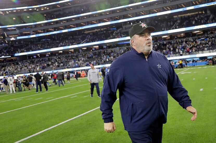 Dallas Cowboys head coach Mike McCarthy breathes a sigh of relief as he walks to the locker...