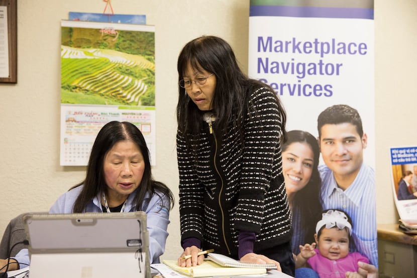 Lisa Pham (left), a Vietnamese-speaking health insurance marketplace navigator, speaks with...