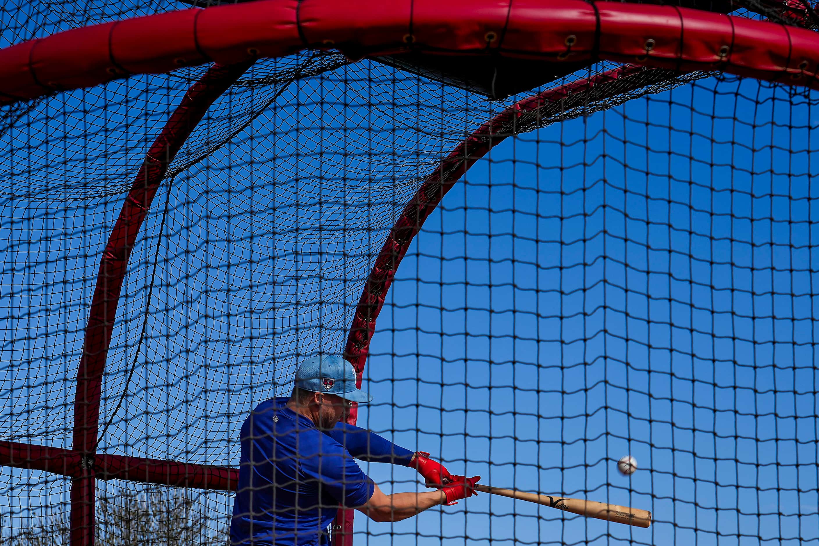 Texas Rangers catcher Andrew Knizner takes batting practice during a spring training workout...