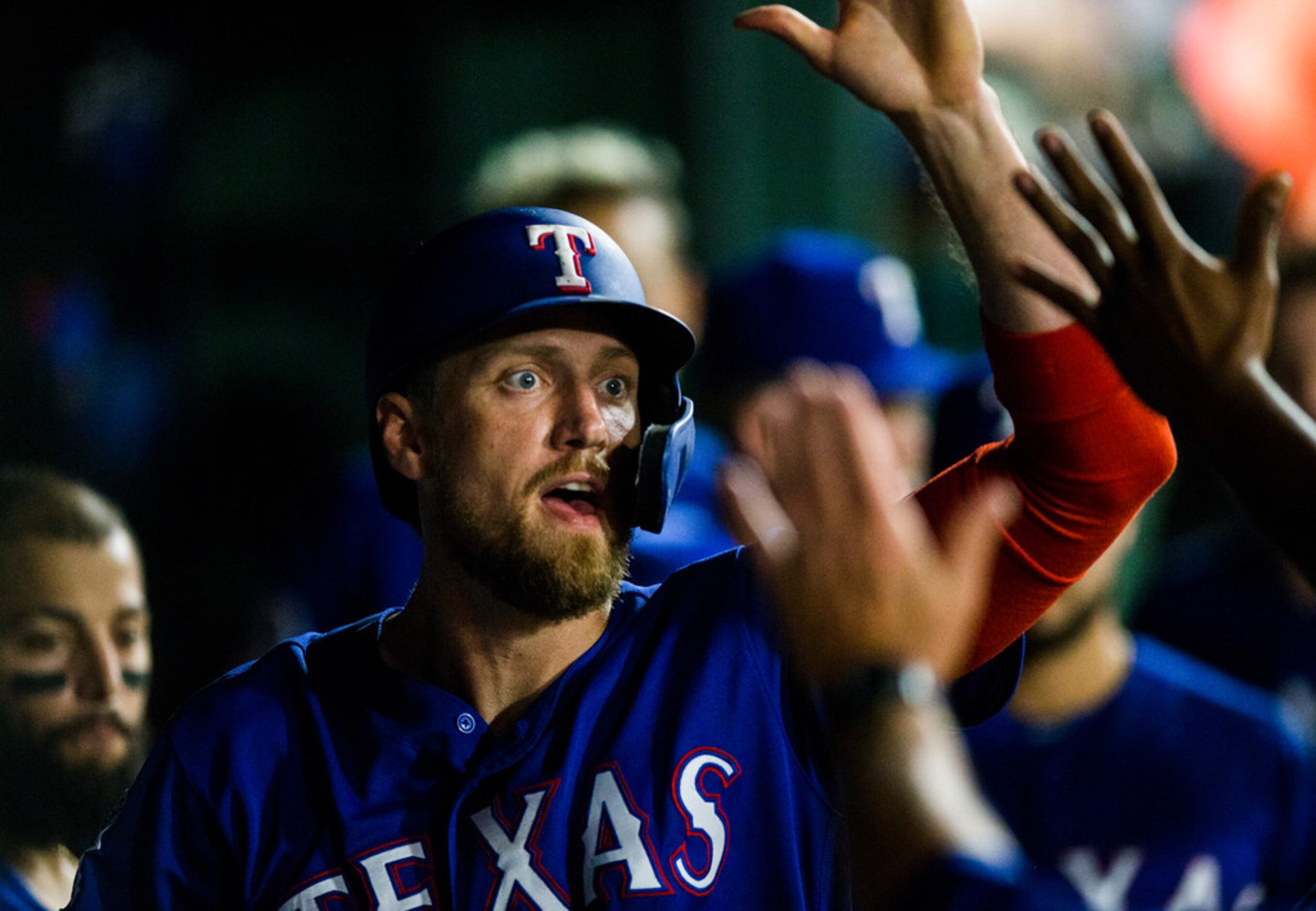 Texas Rangers designated hitter Hunter Pence (24) celebrates a run in the dugout during the...