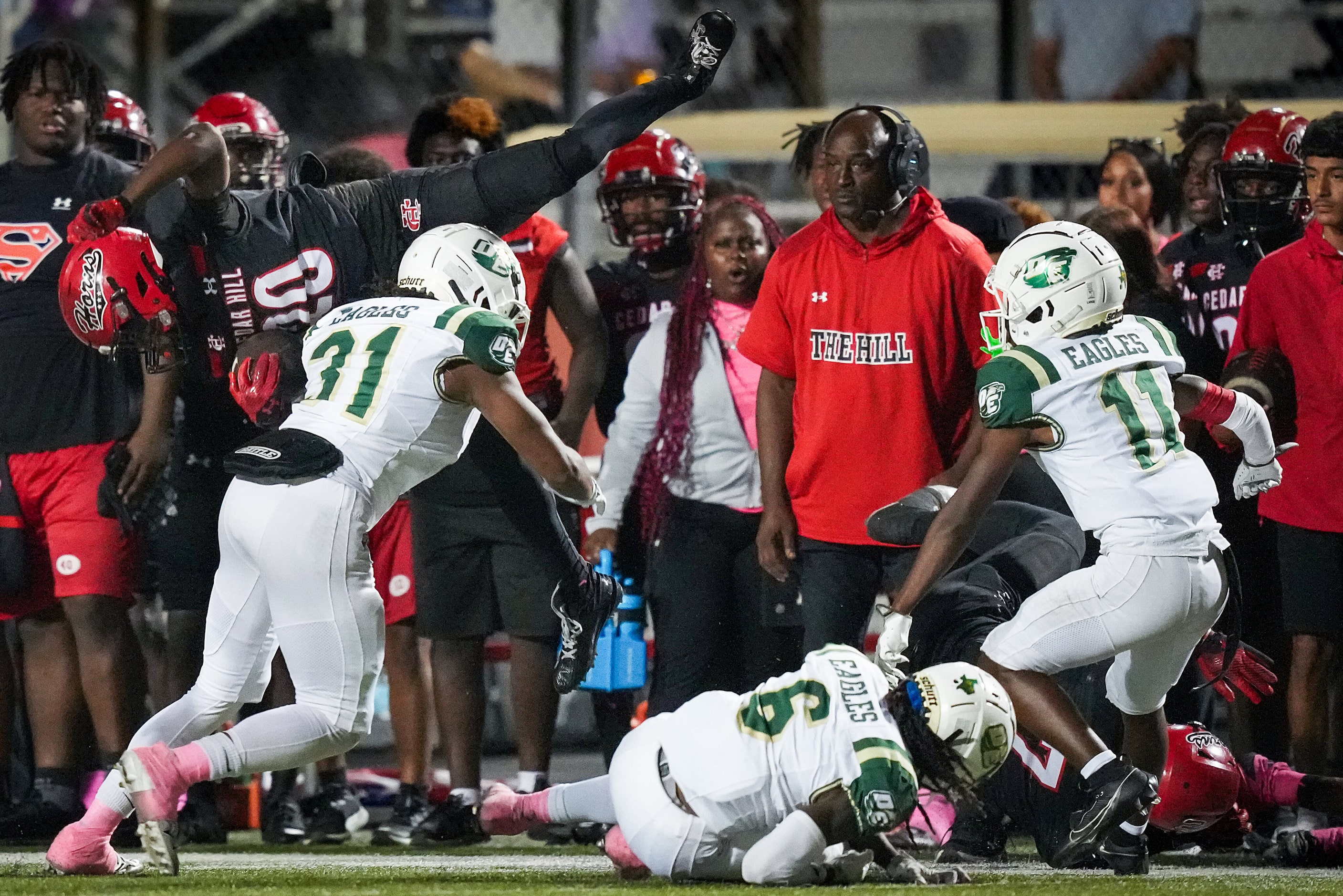 Cedar Hill running back CJ Castleberry (20) is upended by DeSoto linebacker Jackson Curry...