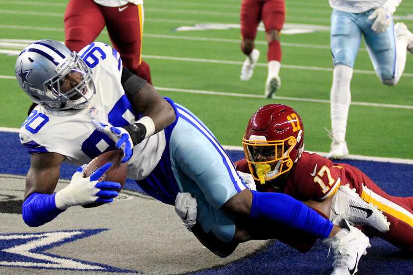 Dallas Cowboys defensive end Demarcus Lawrence (90) falls into the end zone for a touchdown,...