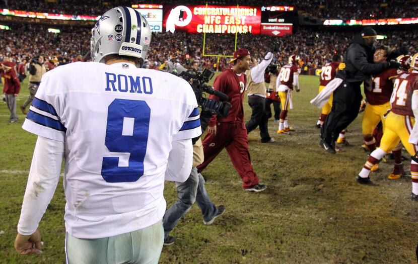 Dallas Cowboys quarterback Tony Romo (9) walks off the field as the Redskins celebrate...