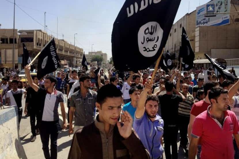 
Demonstrators in Mosul, Iraq, carry al-Qaeda flags and chant slogans to support the Islamic...