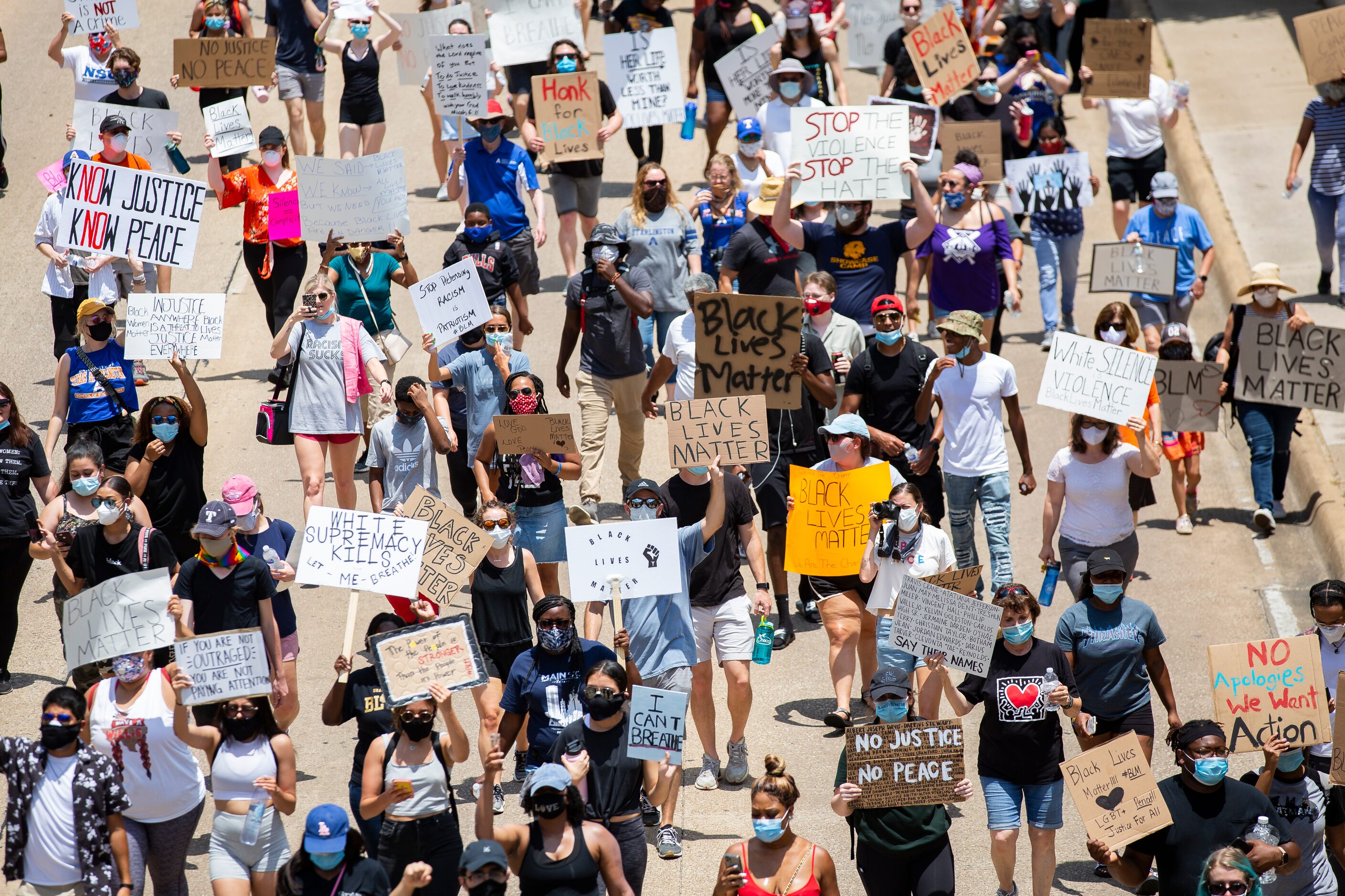 Protestors against police brutality march down S Cooper St as they participate in the UTA...