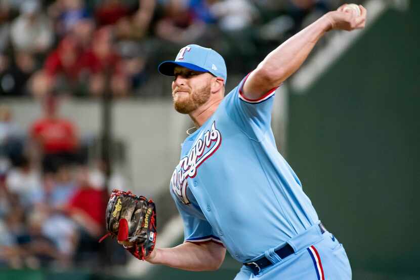 Texas Rangers relief pitcher Will Smith delivers in the top of the ninth inning in a...