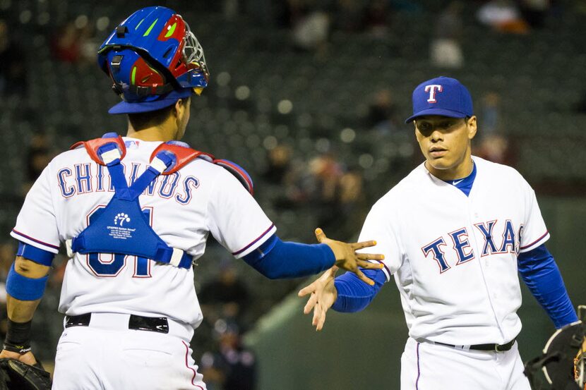 Texas Rangers relief pitcher Keone Kela gets a hand from catcher Robinson Chirinos after the...