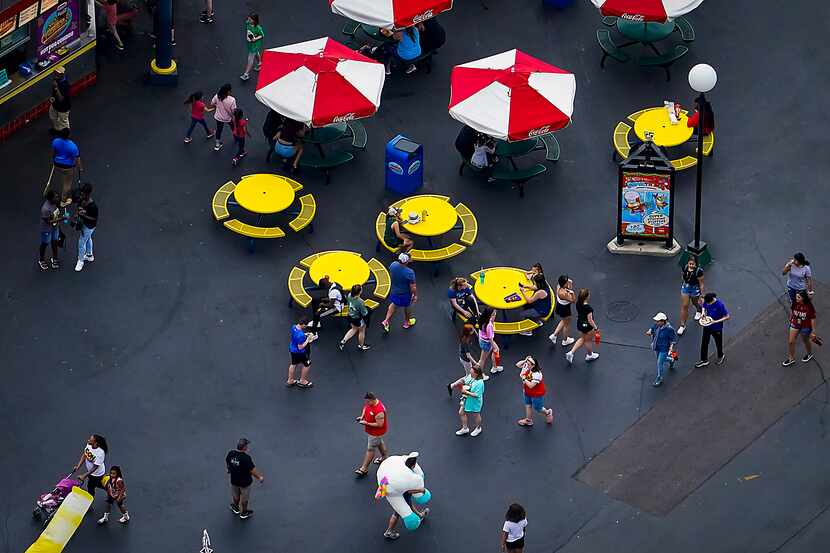 Park visitors walked near a food concession area at Six Flags Over Texas on March 12, 2020,...