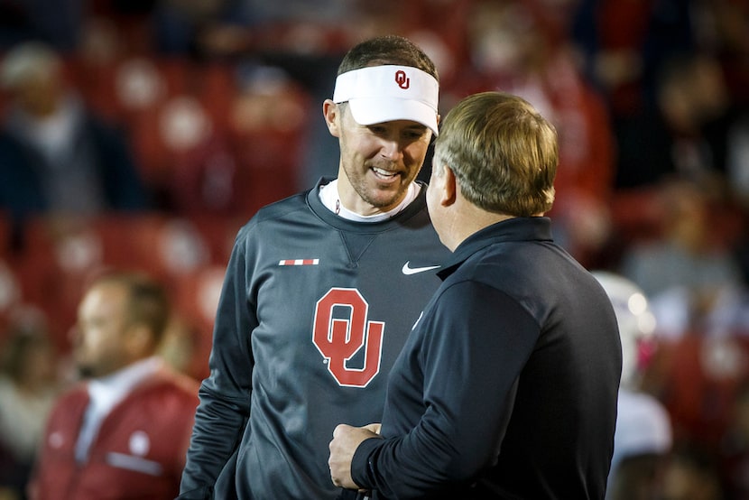 Oklahoma head coach Lincoln Riley chats with TCU head coach Gary Patterson before an NCAA...