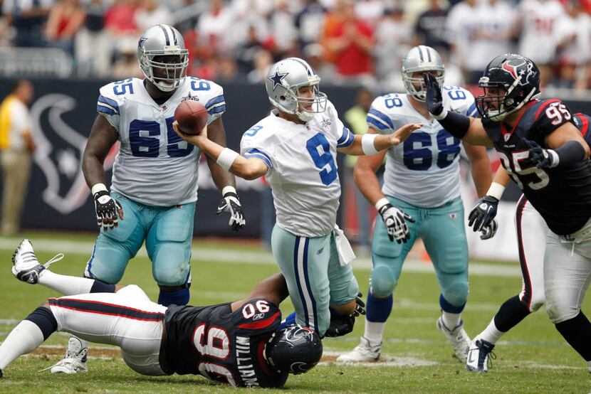 Dallas Cowboys quarterback Tony Romo (9) throws the ball down under pressure (he was...