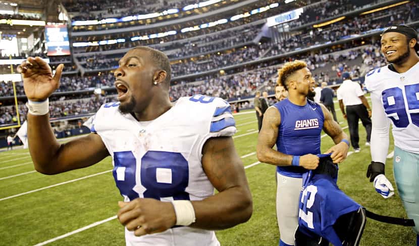 Dallas Cowboys wide receiver Dez Bryant (88) calls back to the bench as he exchanges jerseys...