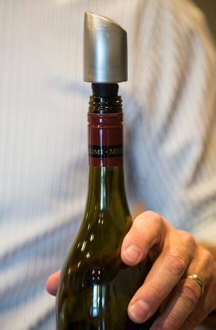 David Meadows shows off a new wine filter that will attach to the top of a wine bottle....