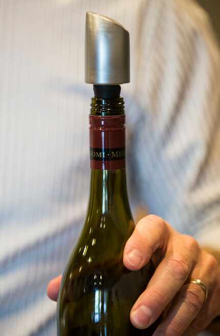 David Meadows shows off a new wine filter that will attach to the top of a wine bottle....