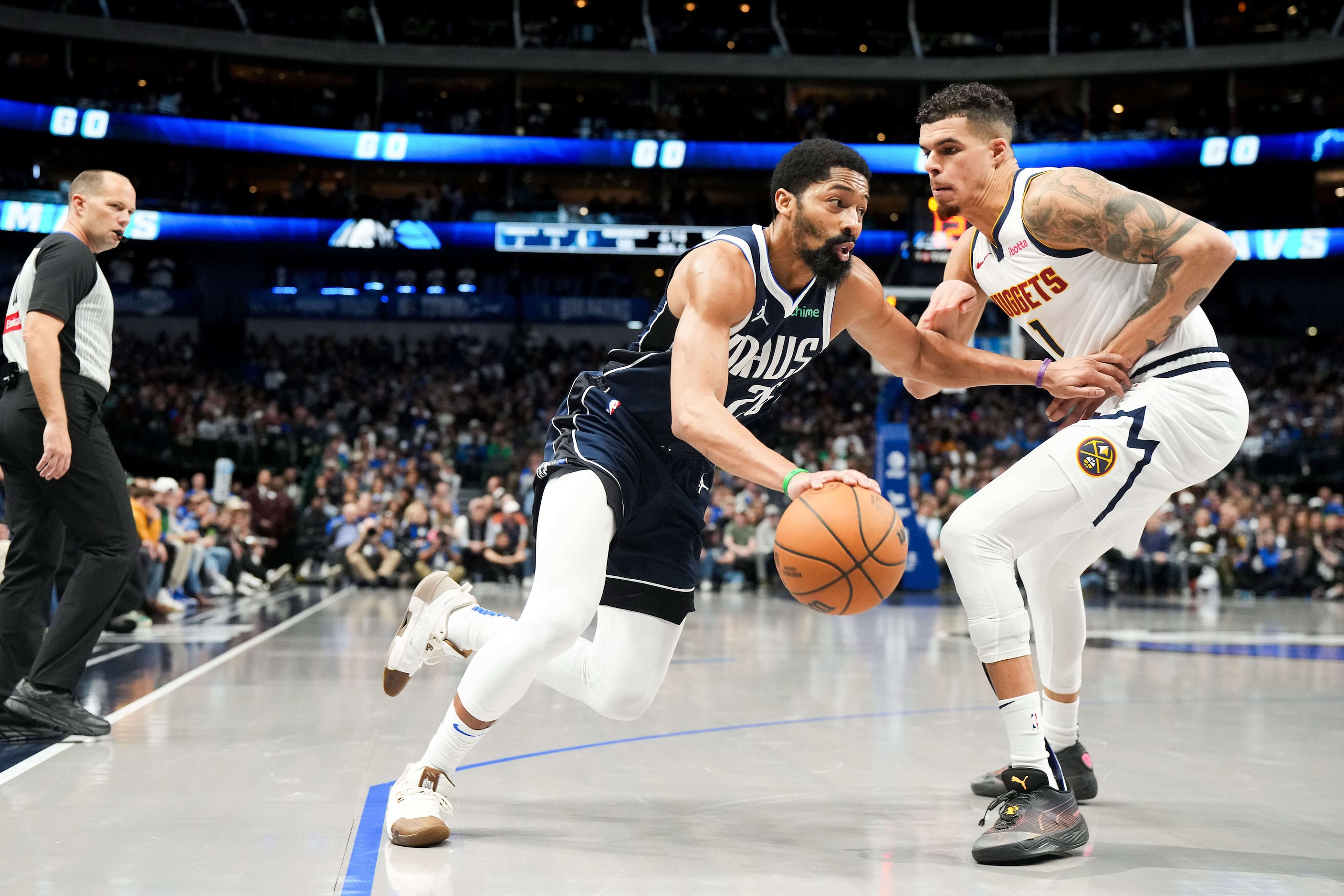 Dallas Mavericks guard Spencer Dinwiddie (26) drives against Denver Nuggets forward Michael...