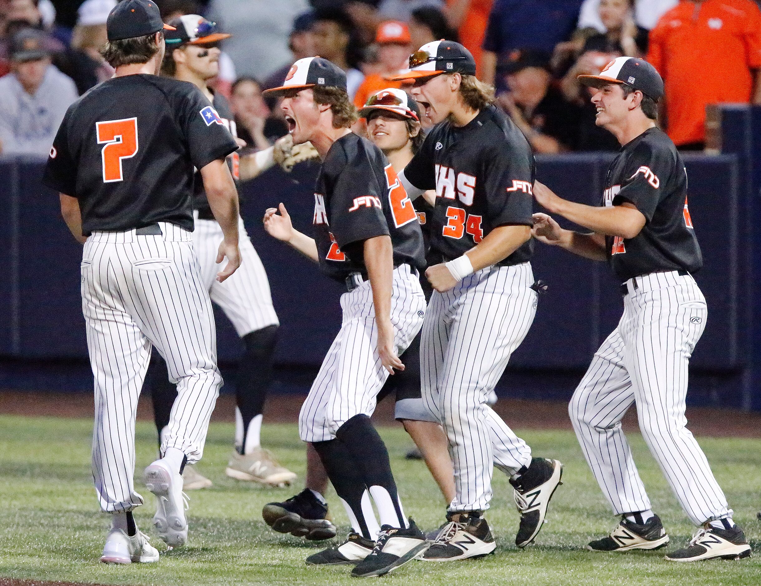 The dugout runs out to congratulate Rockwall pitcher Daniel Ciunningham (7) after he got out...