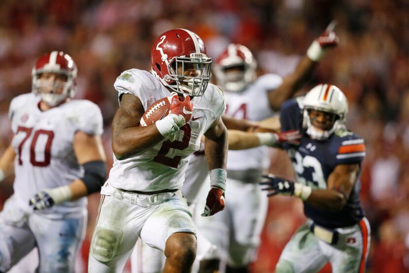 FILE - In this Nov. 28, 2015, file photo, Alabama running back Derrick Henry (2) runs for a...