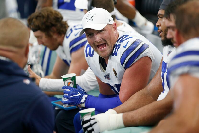 Dallas Cowboys tight end Jason Witten (82) talks on the sidelines to teammates during the...
