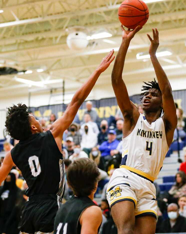 Guyer High School Jordan Lowery (0) defends McKinney High School Ja'Kobe Walter (4) as he...