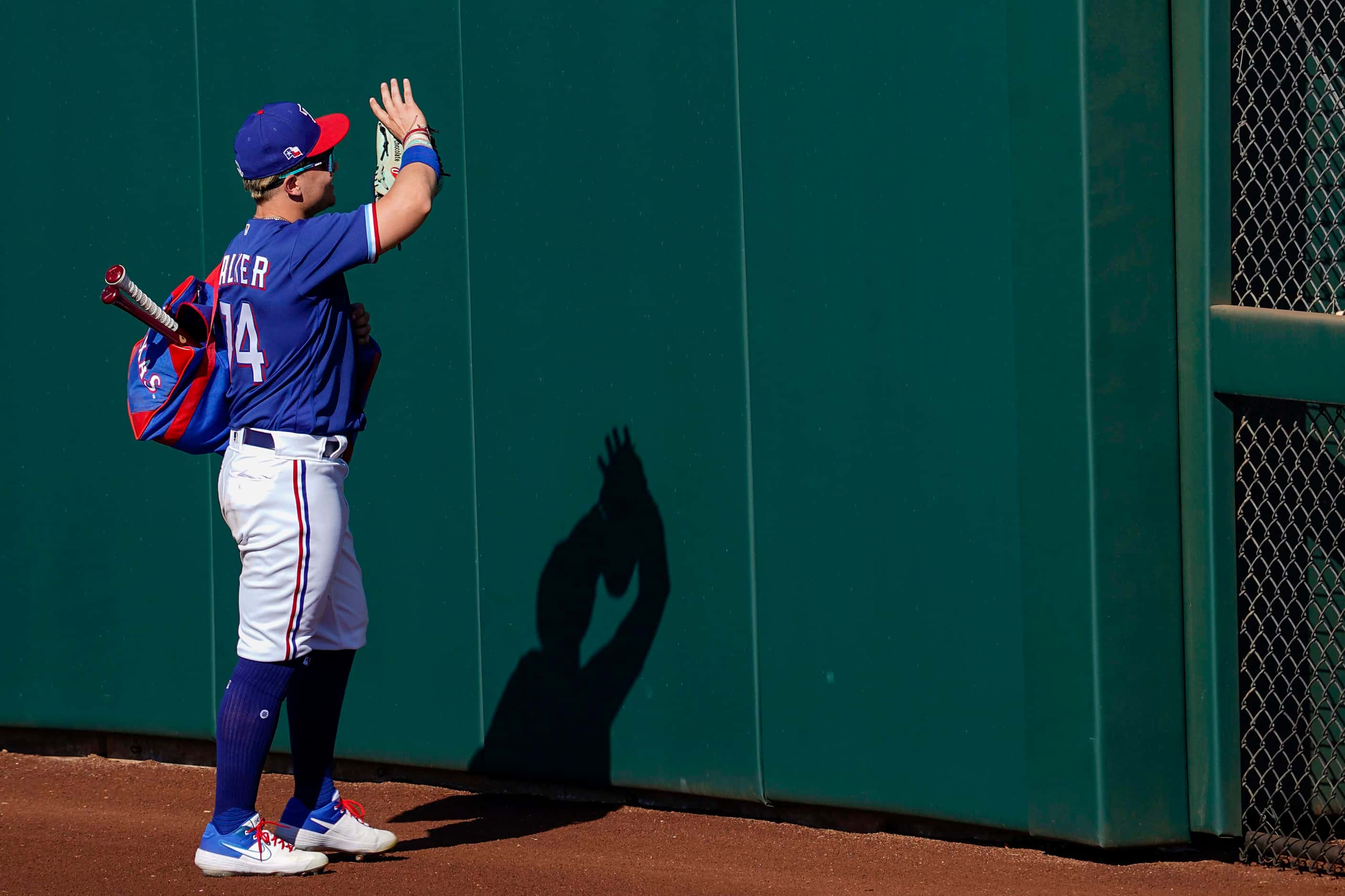Texas Rangers outfielder Steele Walker waves to fans as he leaves the field after a spring...