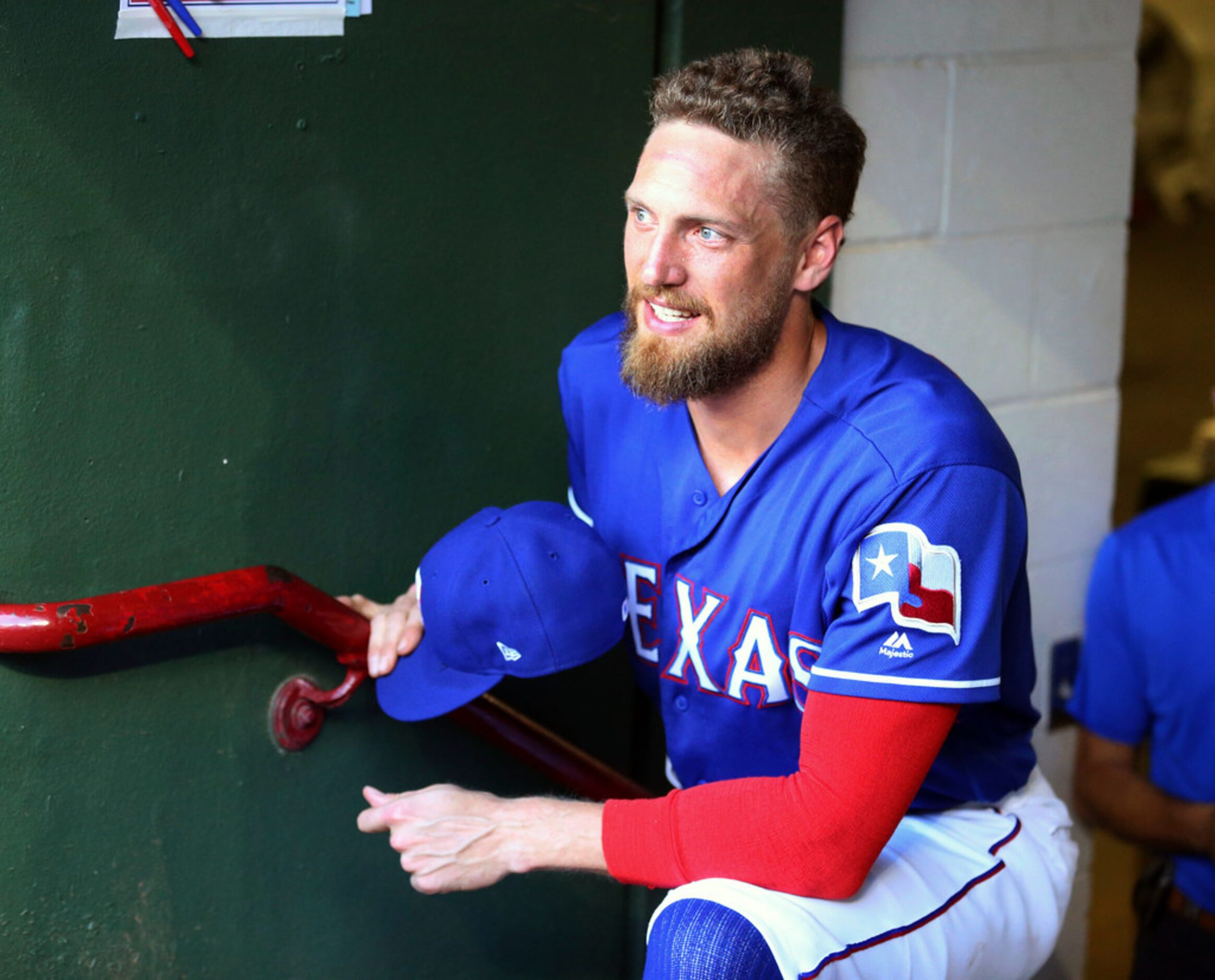 Texas Rangers designated hitter Hunter Pence (24) stands in the dugout before a baseball...