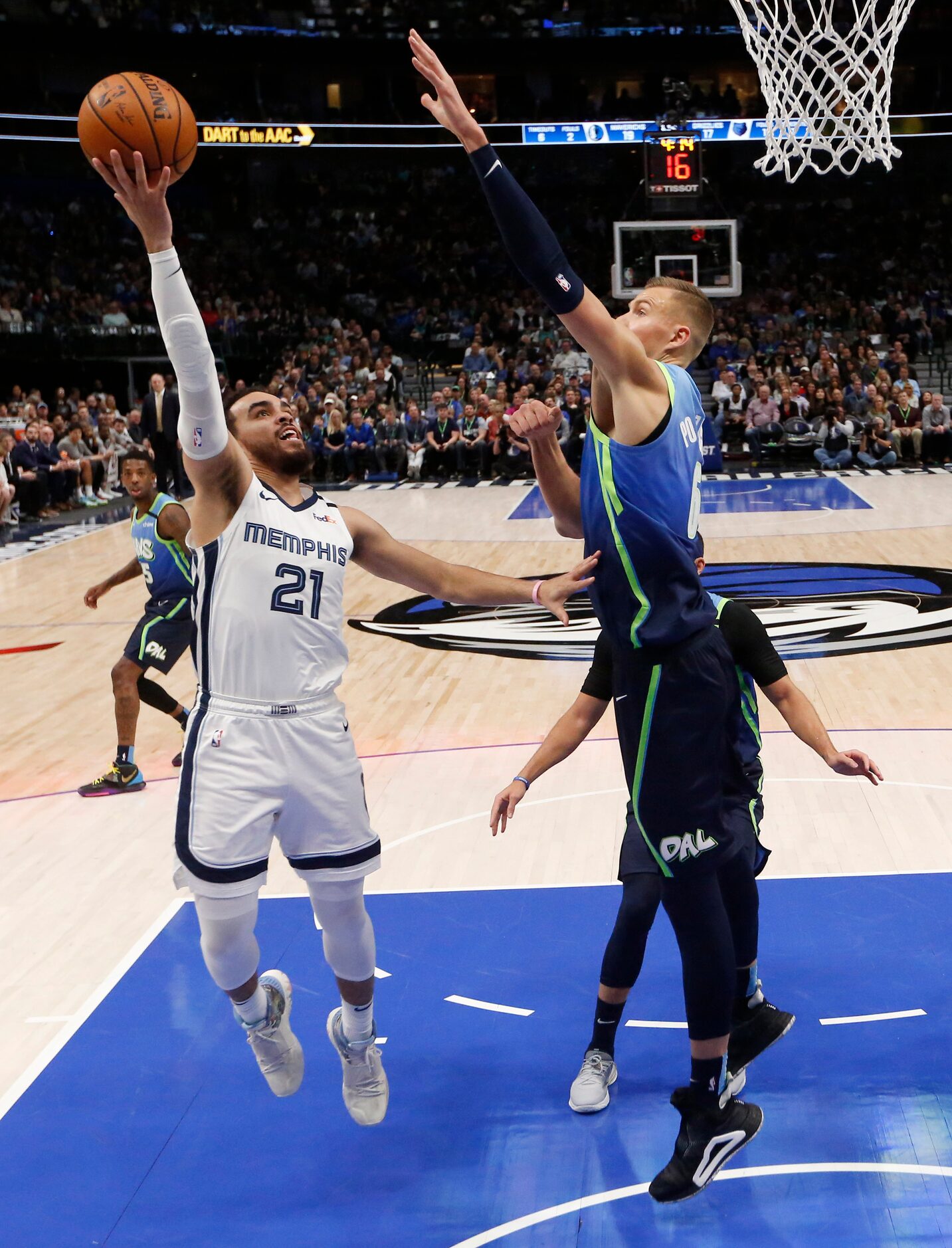 Dallas Mavericks forward Kristaps Porzingis (6) contests a shot from Memphis Grizzlies guard...