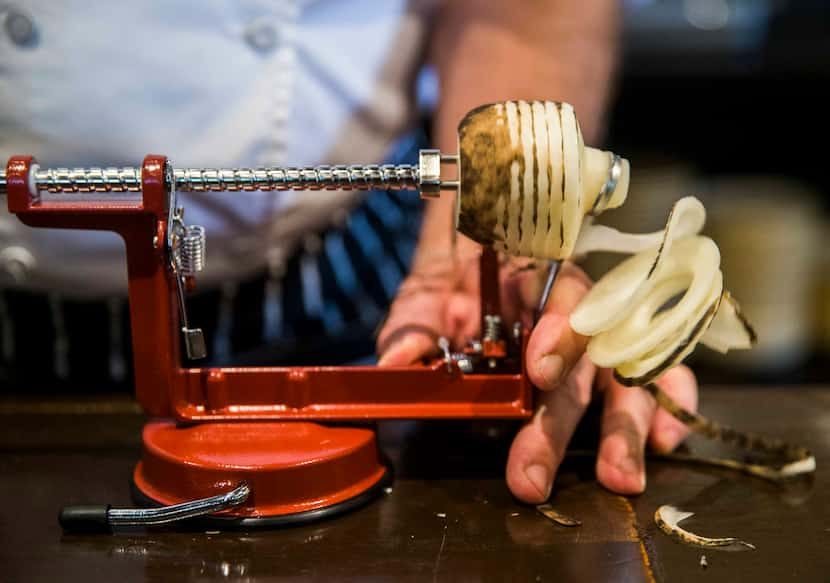 Chef Graham Dodds uses a spiralizer on a radish on Thursday, March 31, 2016 at Wayward Sons...