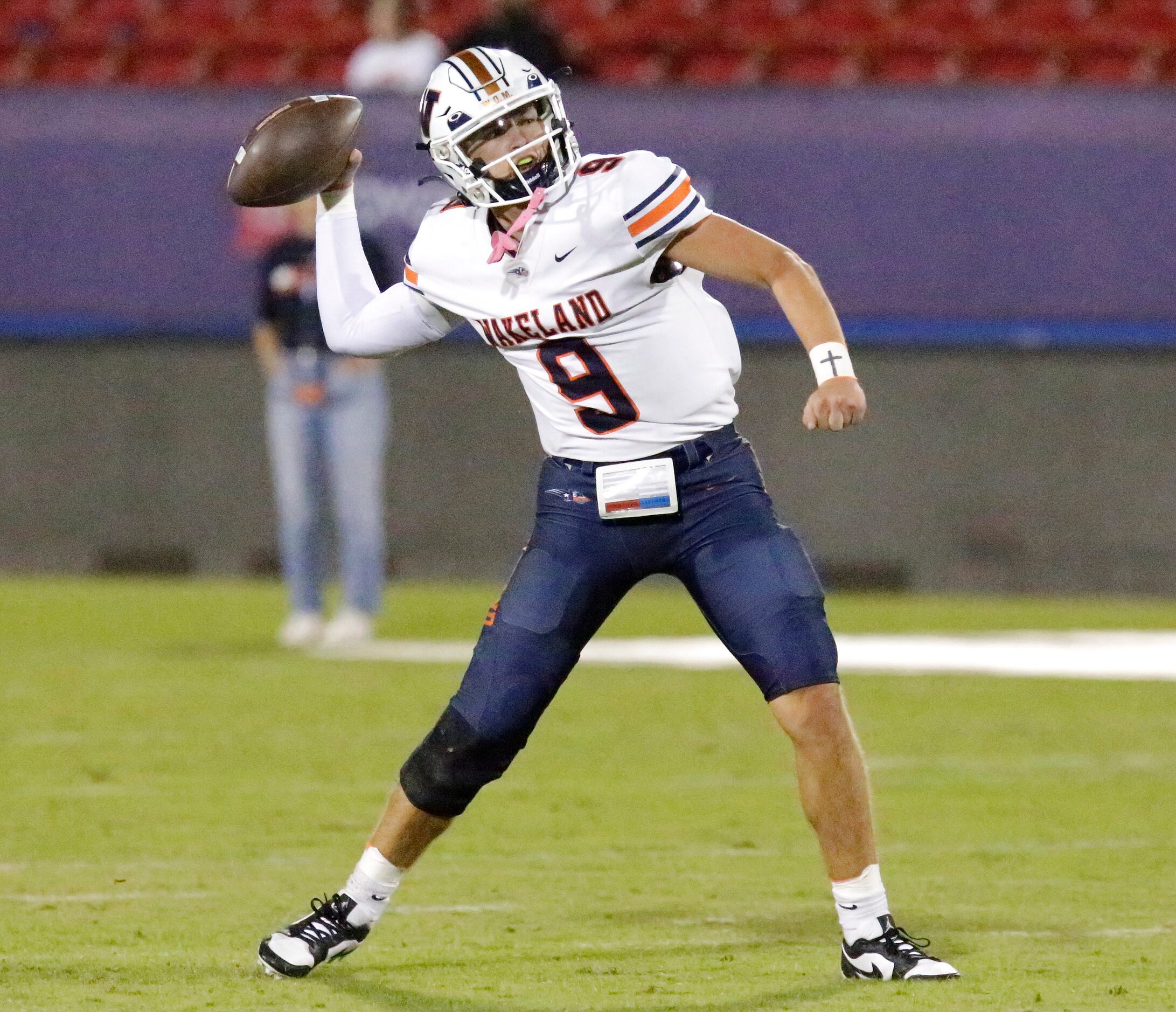 Wakeland High School quarterback Brennan Myer (9) throws a pass during the first half as...