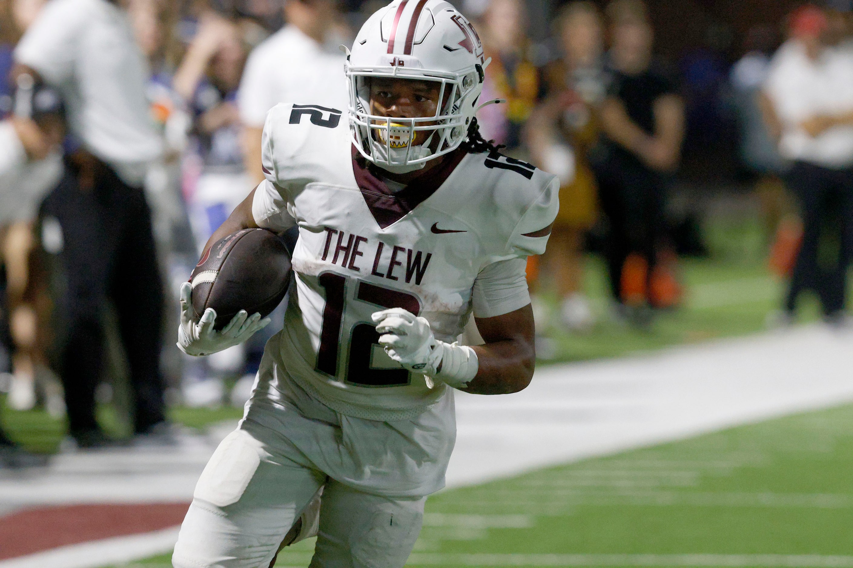 Lewisville's Derrick Martin (12) runs into the end zone for a touchdown against Byron Nelson...