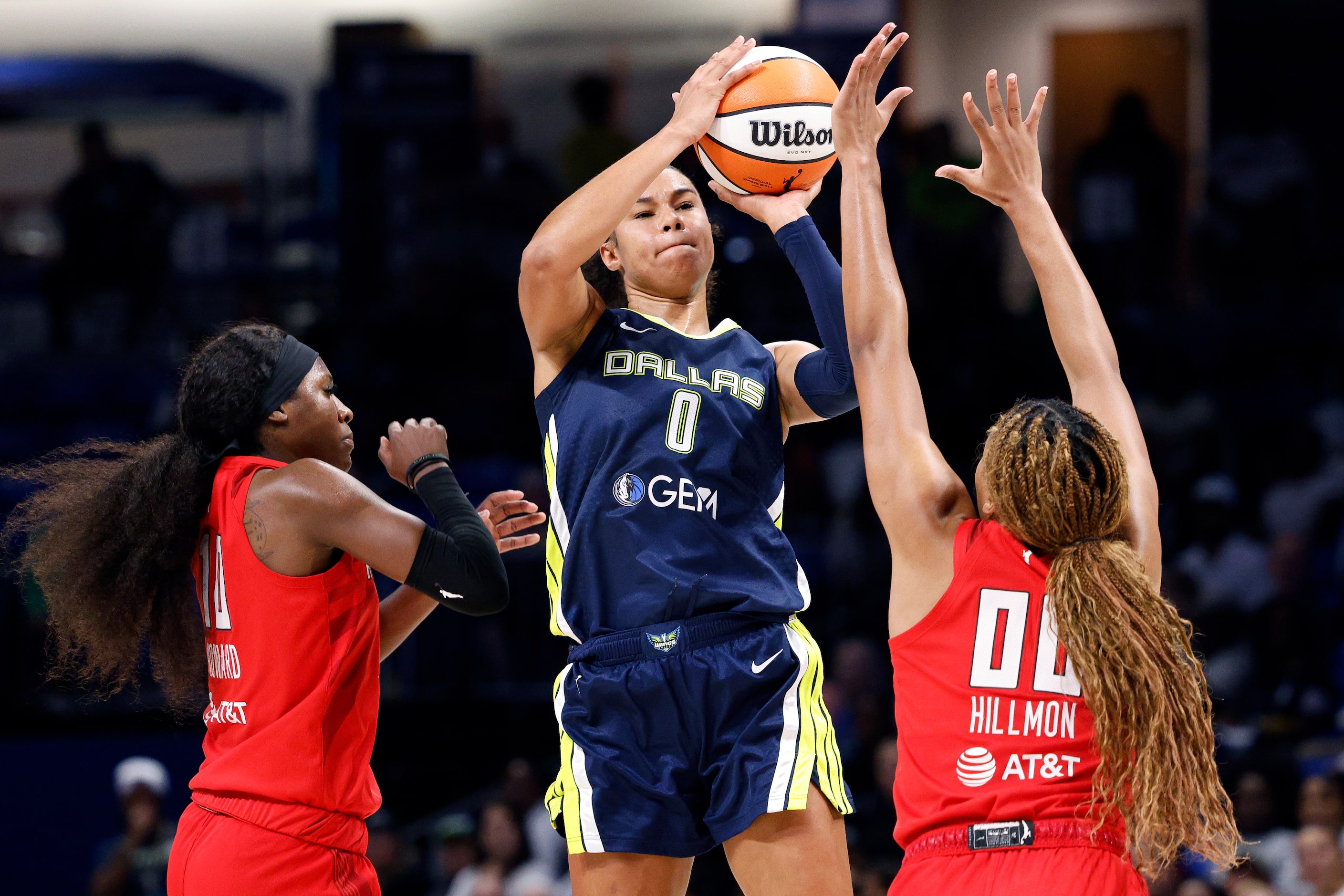 Dallas Wings forward Satou Sabally (0) shoots over Atlanta Dream guard Rhyne Howard (10) and...