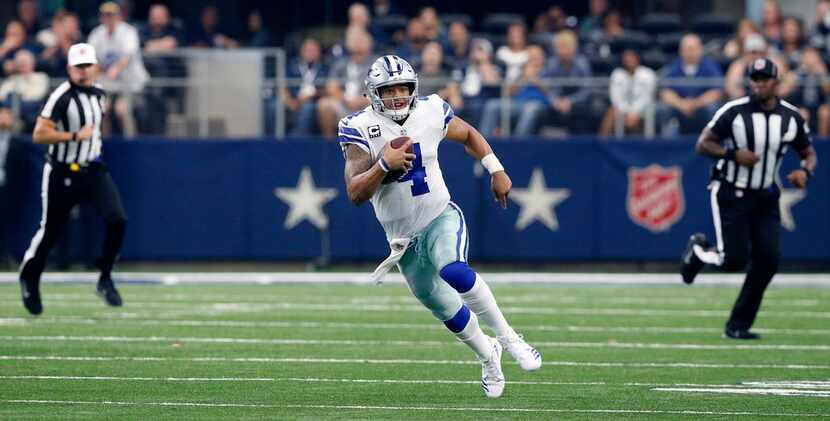 Dallas Cowboys quarterback Dak Prescott (4) takes off running as he has plenty of room...