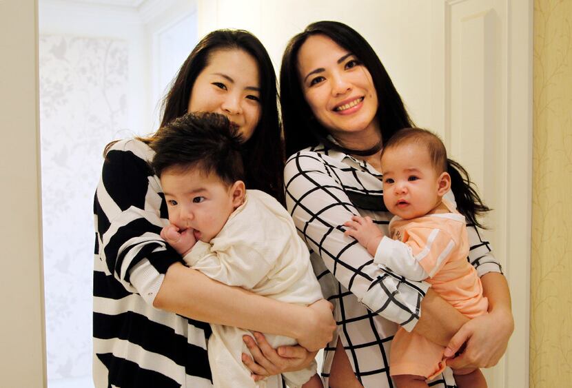 Cindy Su (left) and Lana Yu cradle their babies in Taipei, Taiwan. (Chiang Ying-ying/The...